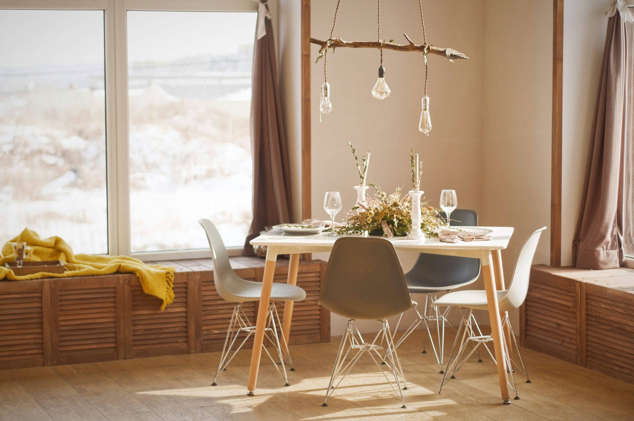 a dining table with four chairs in dining hall